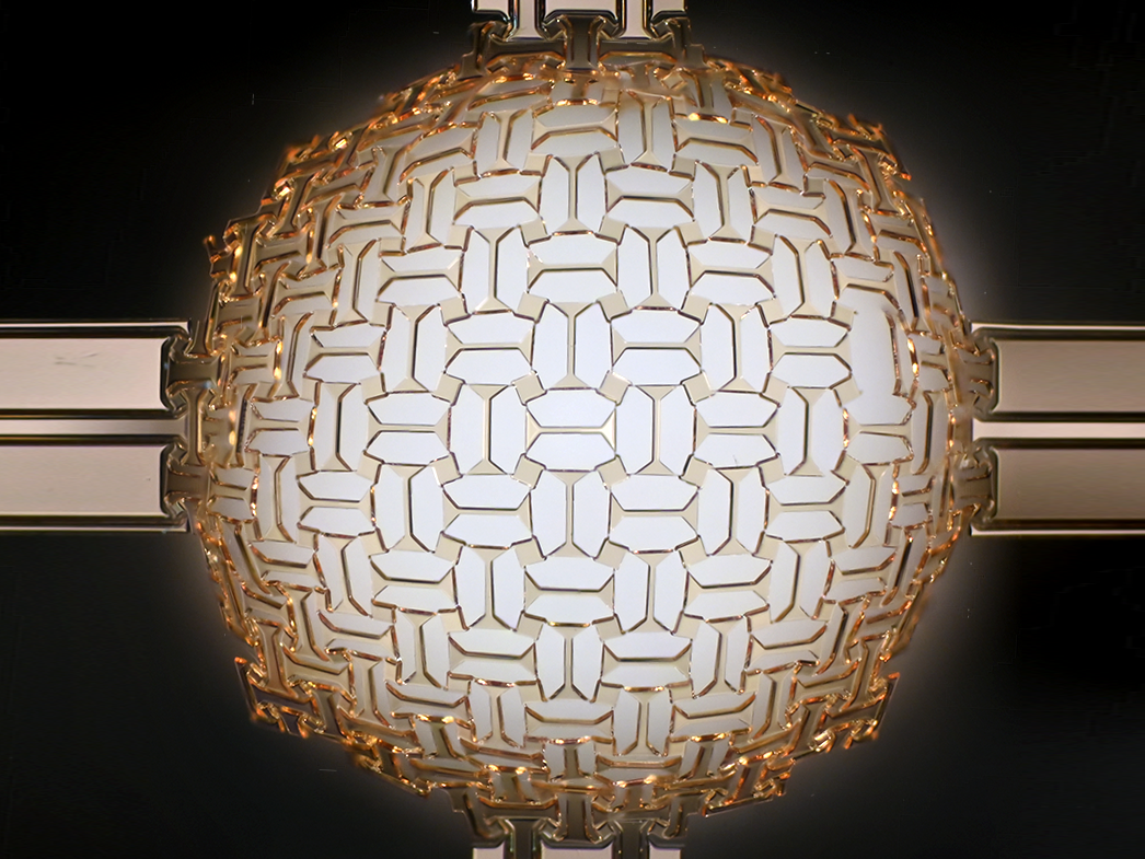 A wafer-fabricated planar precursor deploying into a doubly-curved 3D dome