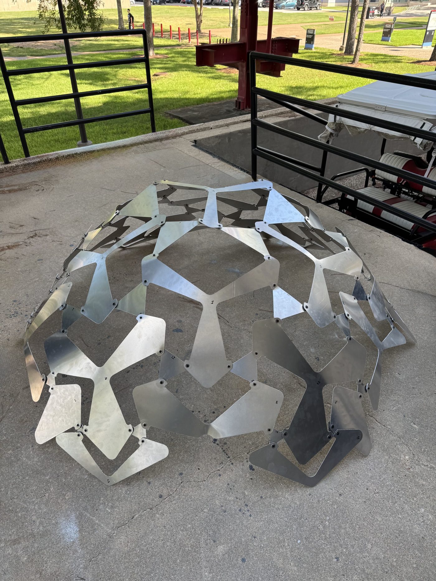 The same aluminium assembly deployed into a free-standing dome about 1.5 m across on a concrete floor