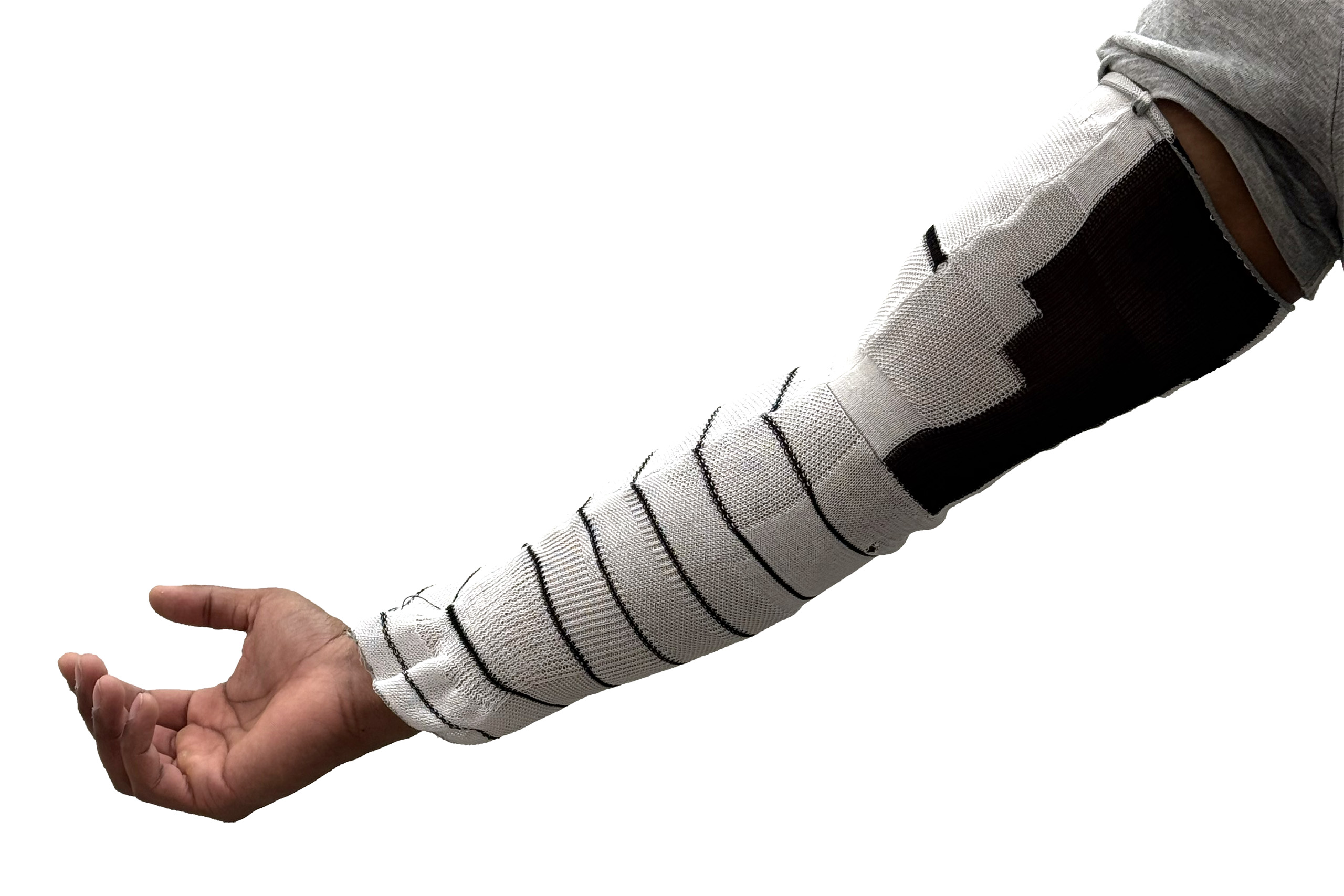 A computationally designed knitted compression sleeve worn on an arm, with microscope close-ups of the three knit patterns it combines